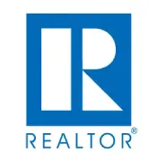 A blue and white logo for realtor. Com